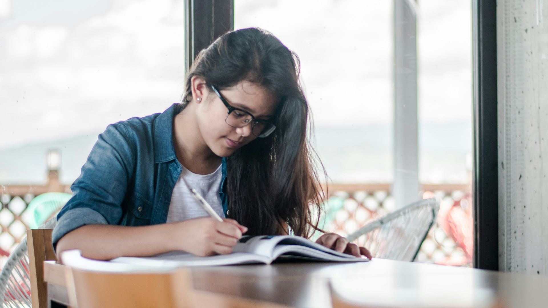 woman writing on book