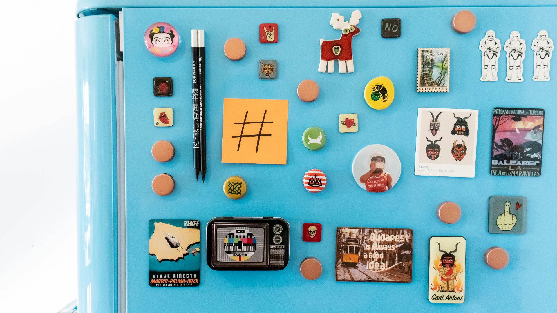 a blue refrigerator with magnets and pictures on it