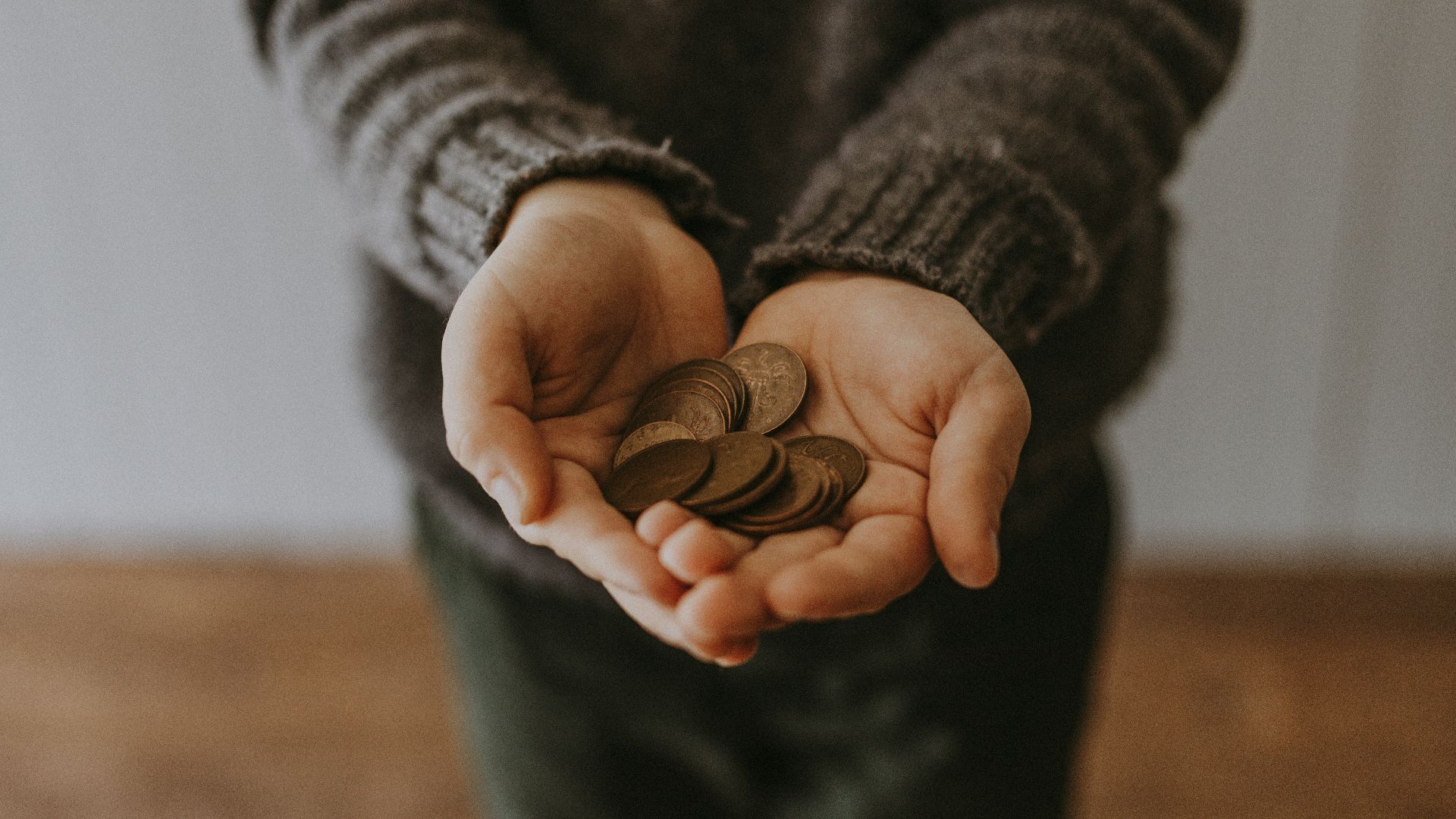 copper-colored coins on in person's hands