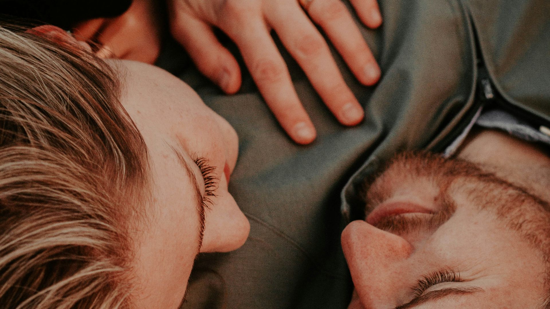 a woman stares into a man's eyes lovingly