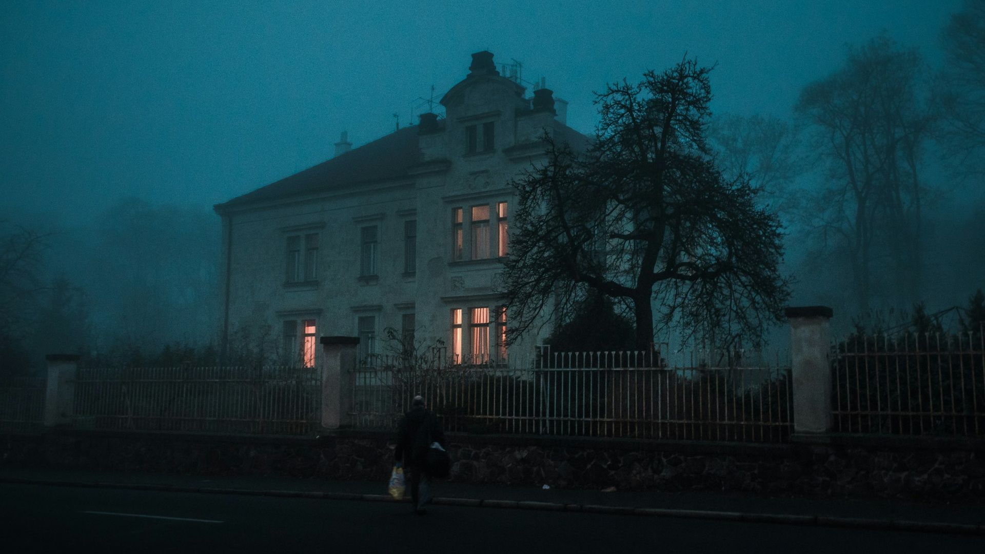 person walking towards house