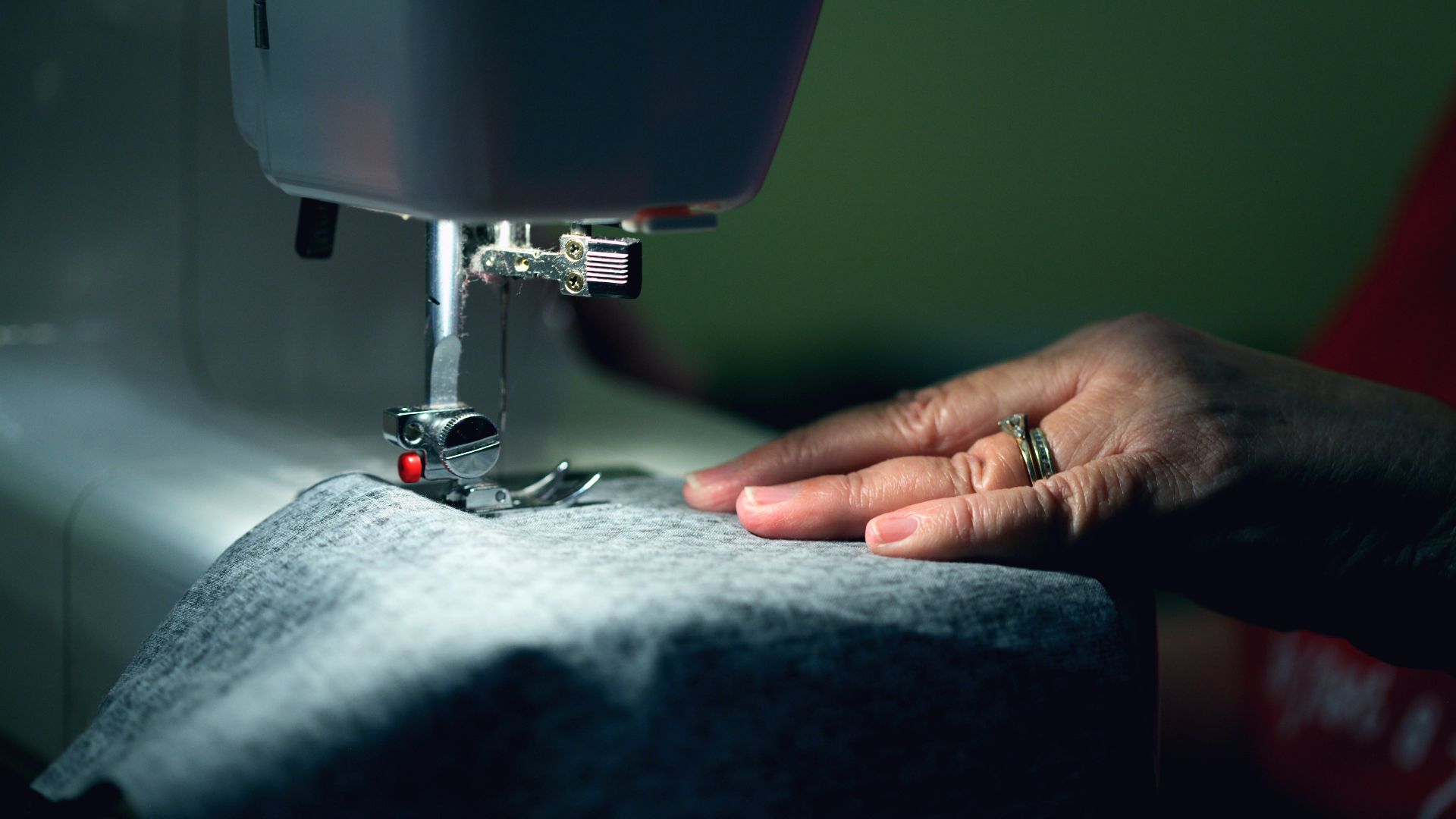 person in gray shirt sewing