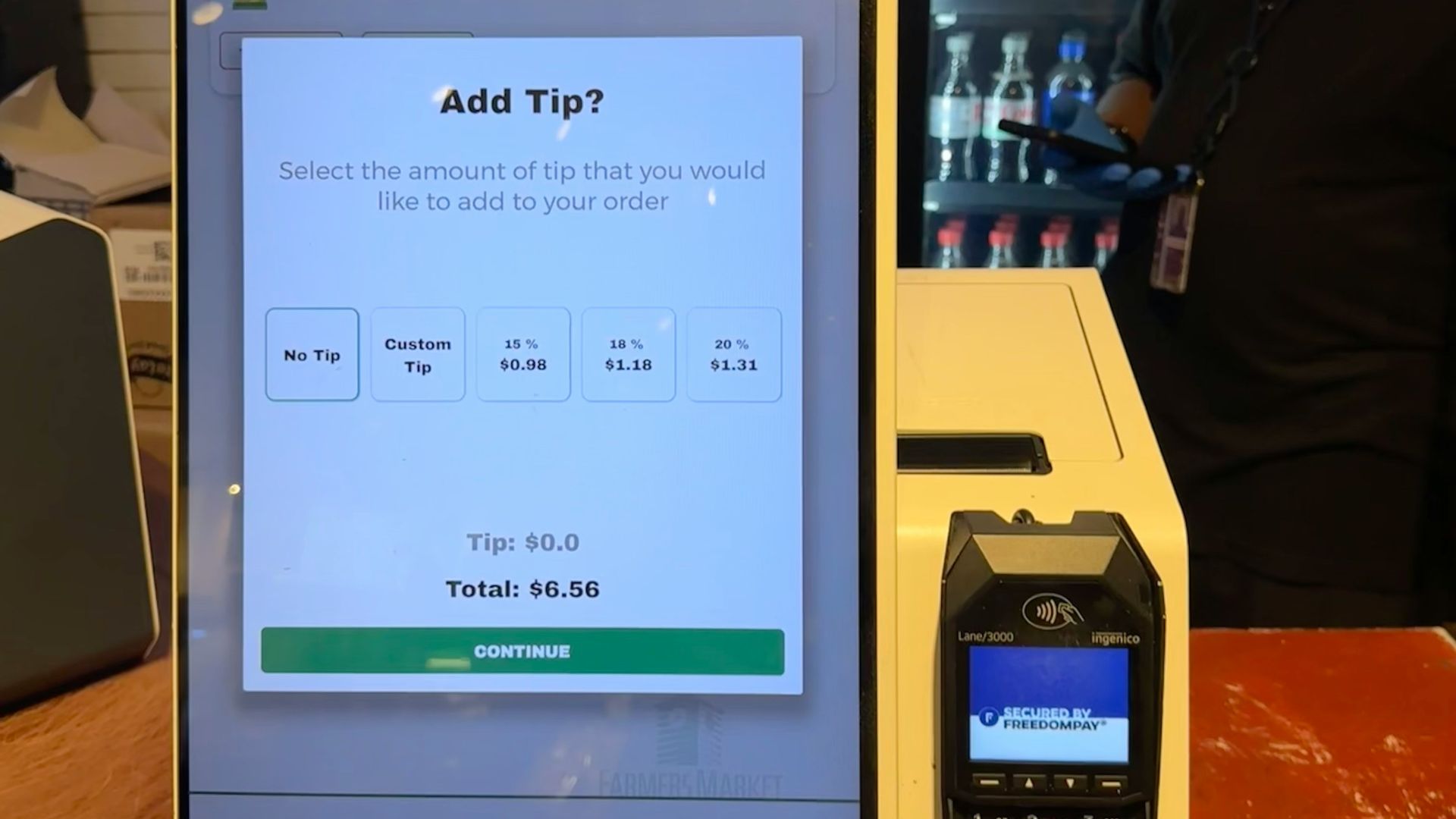 A checkout counter with a cell phone on it