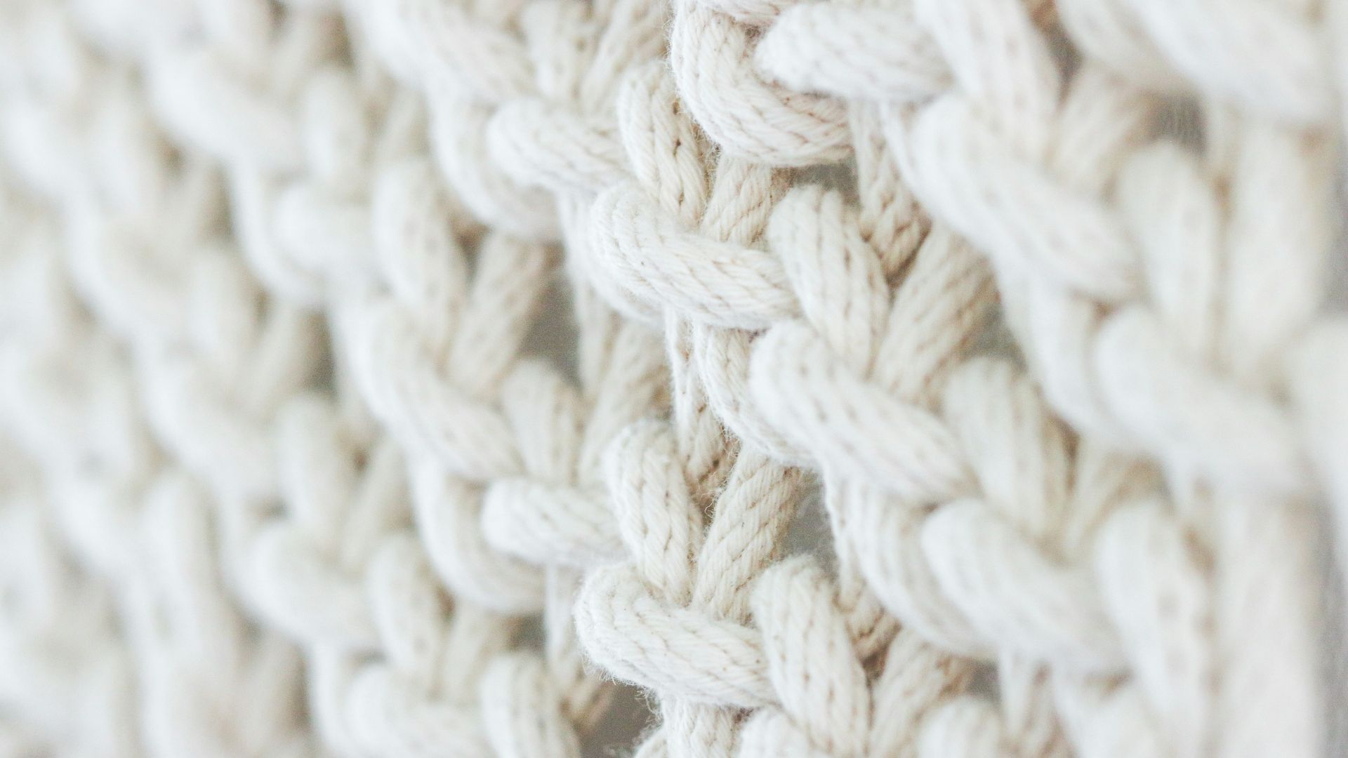 white knit textile on brown wooden table