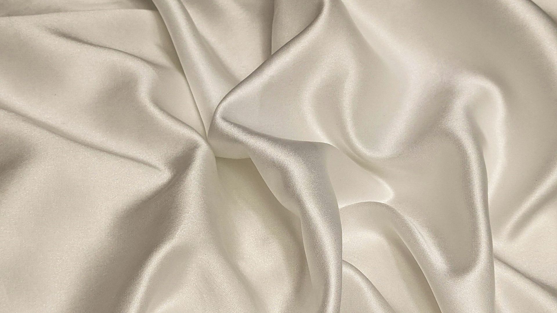 white textile on brown wooden table