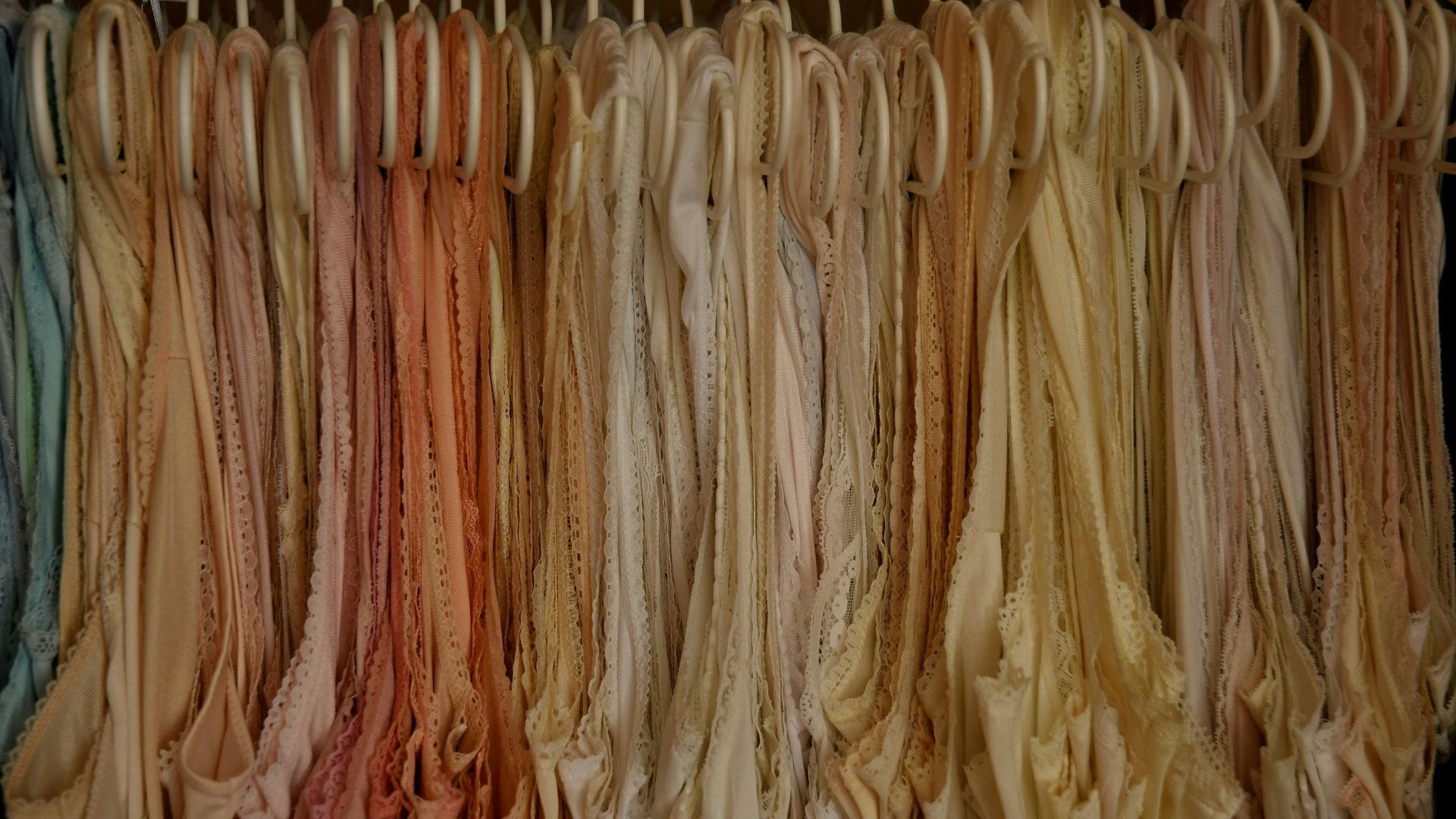 a bunch of clothes hanging on a rack