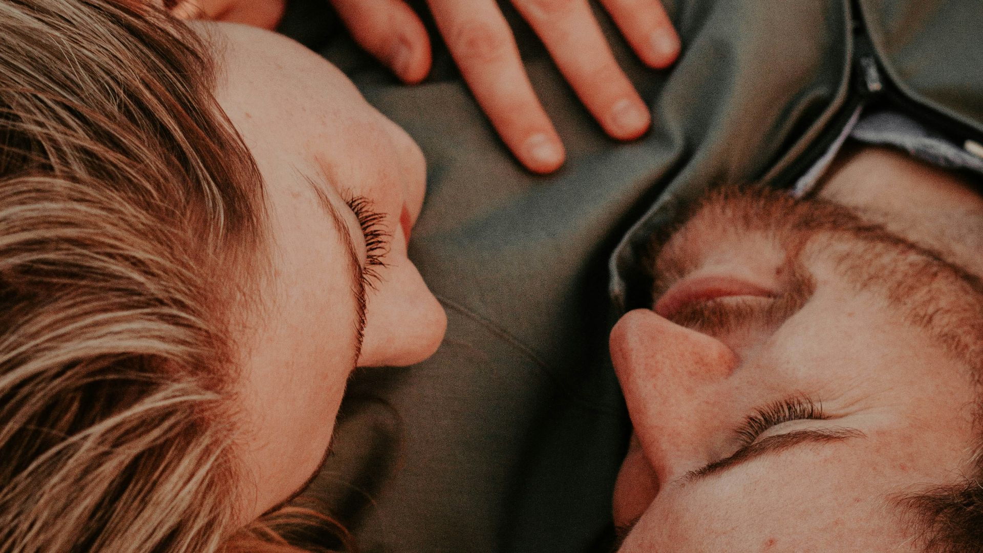 a woman stares into a man's eyes lovingly