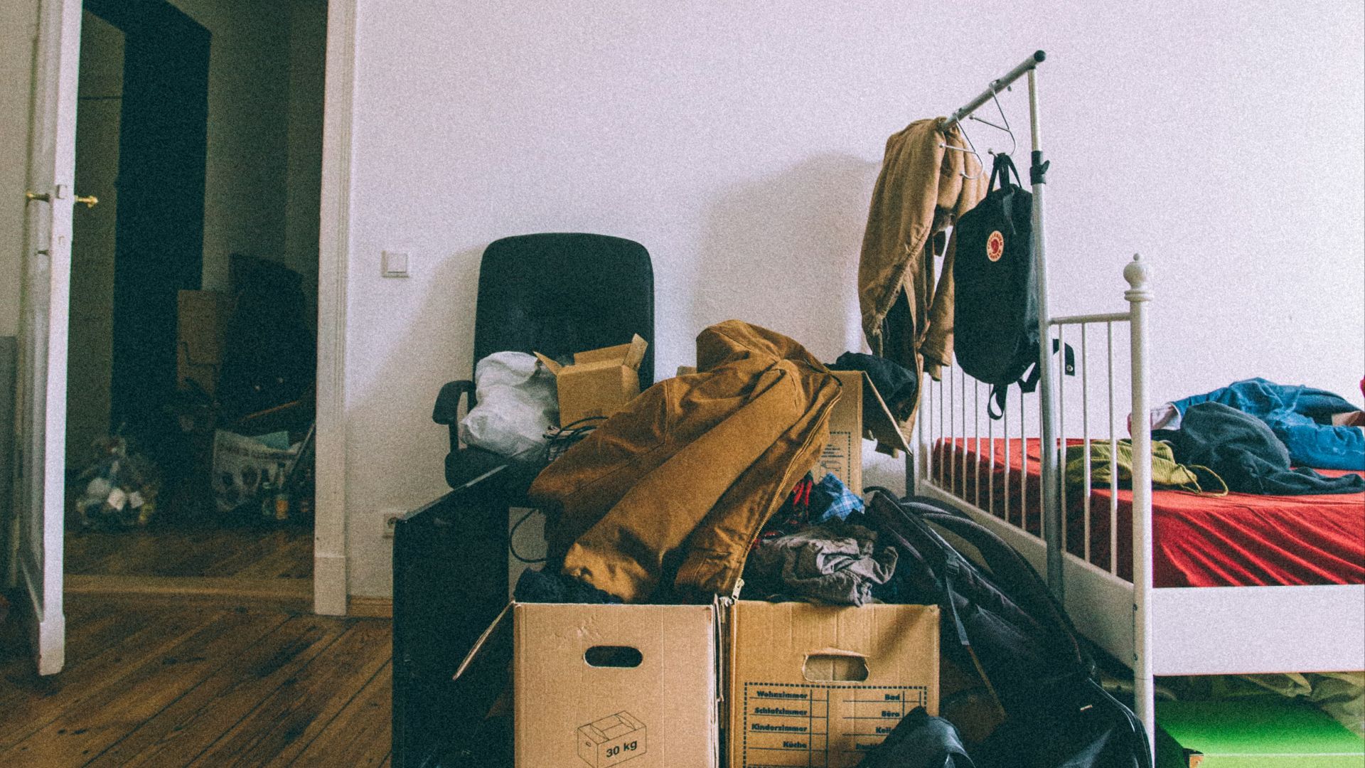 brown cardboard boxes on brown wooden parquet floor