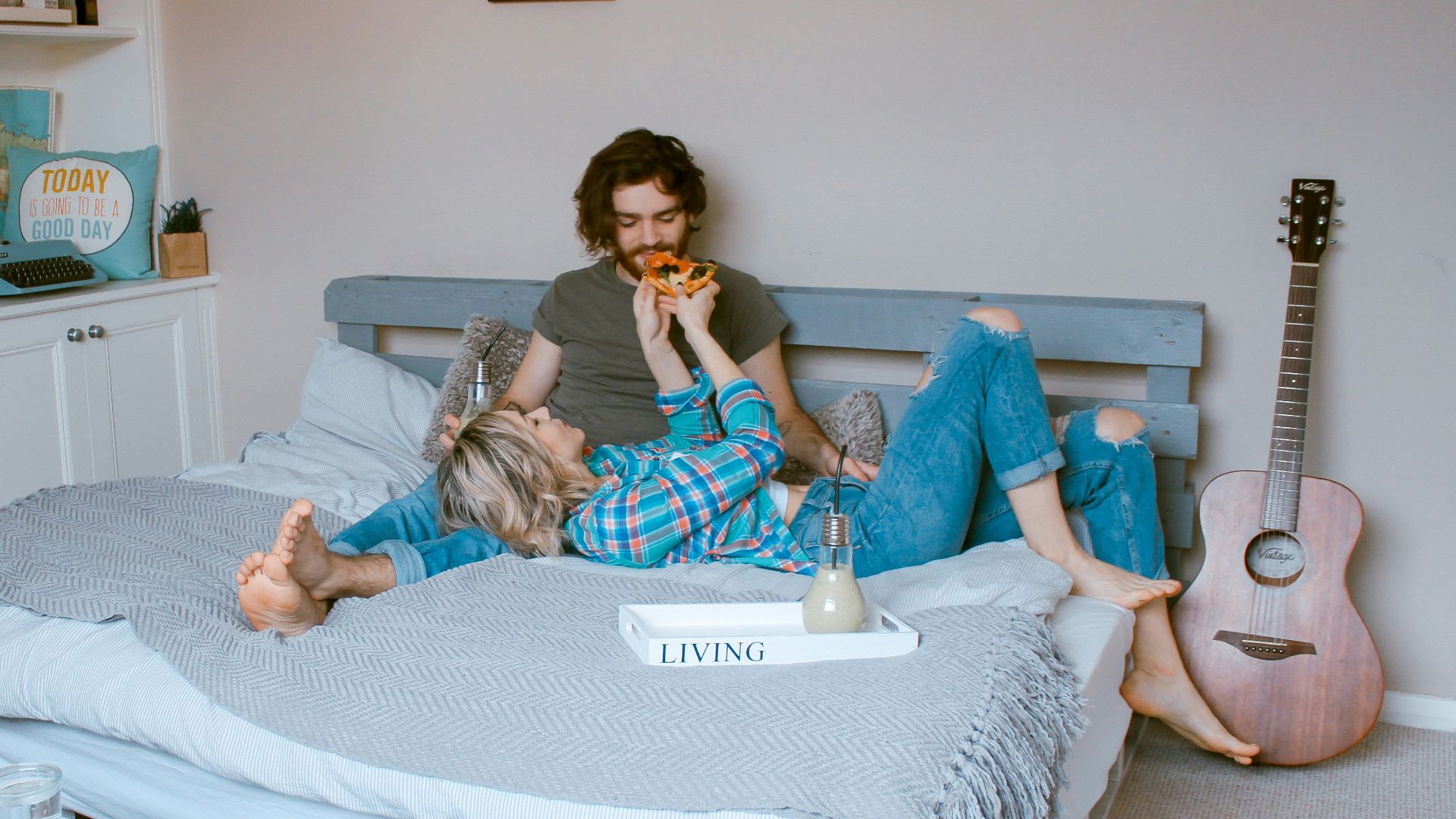 man and woman lying on bed