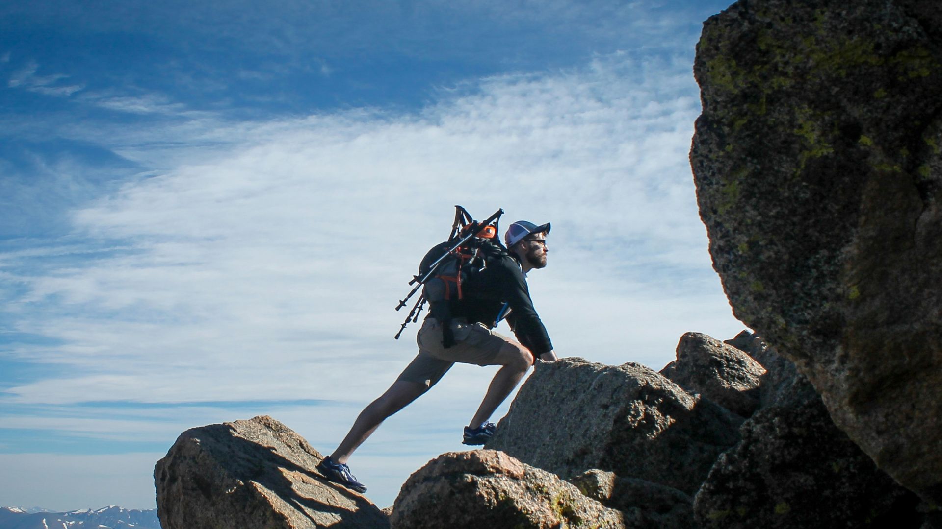 photo of man climbing mountain
