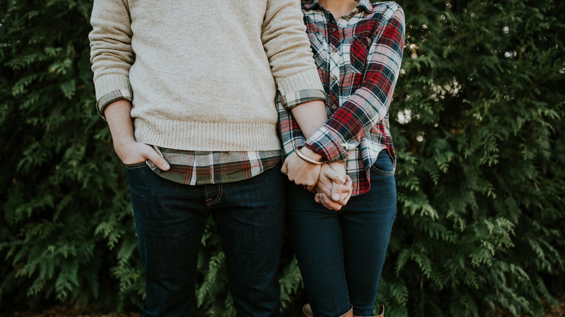 woman holding man hand