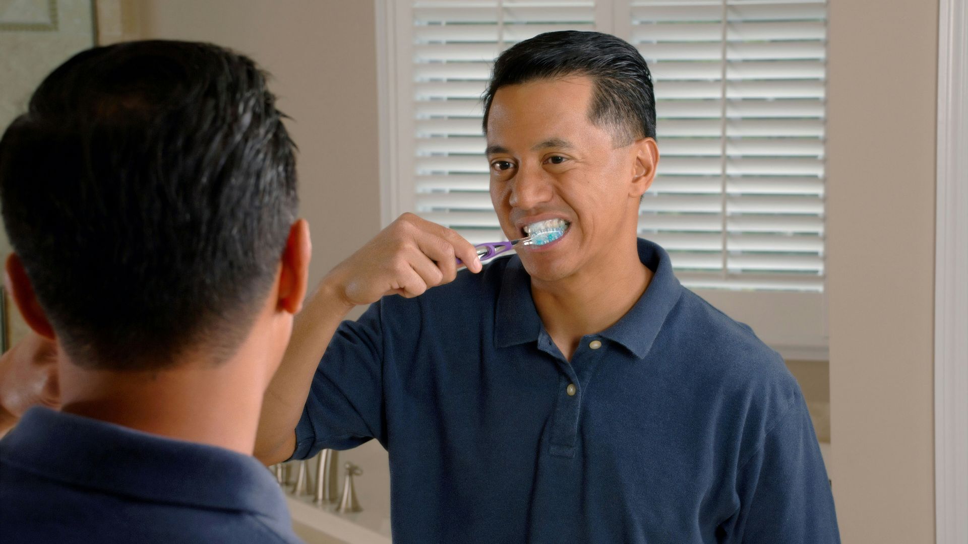 man in blue polo shirt smoking cigarette