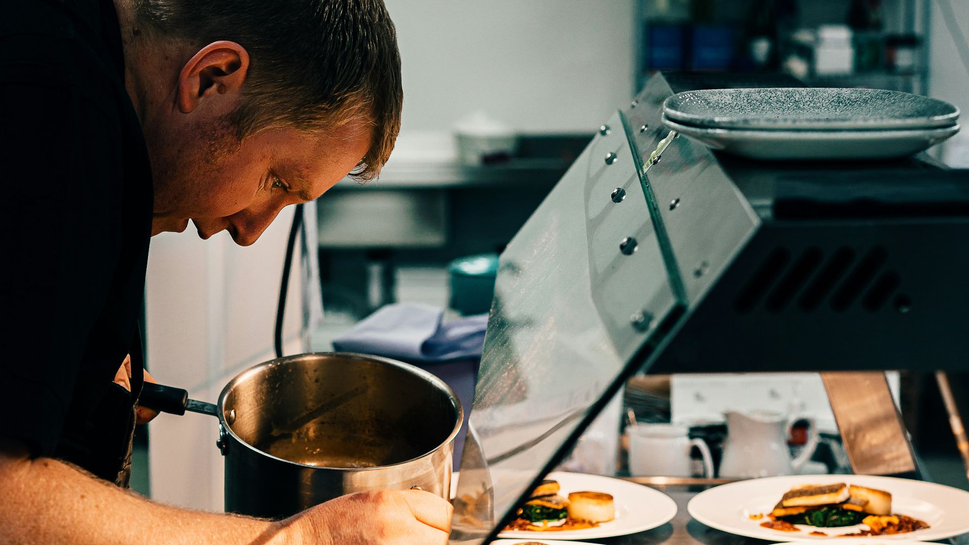 man in black t-shirt holding stainless steel bowl