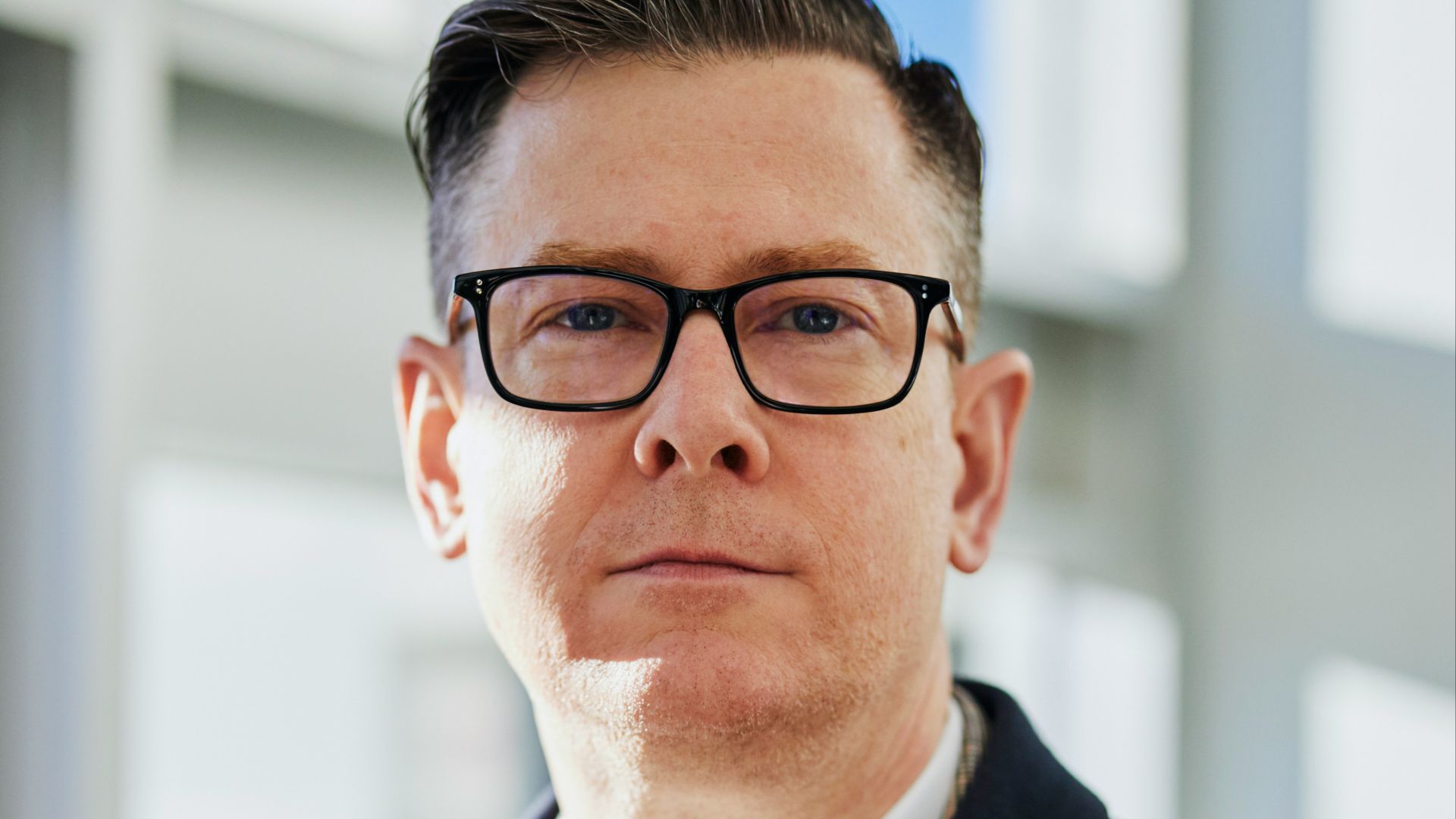 man standing beside wall