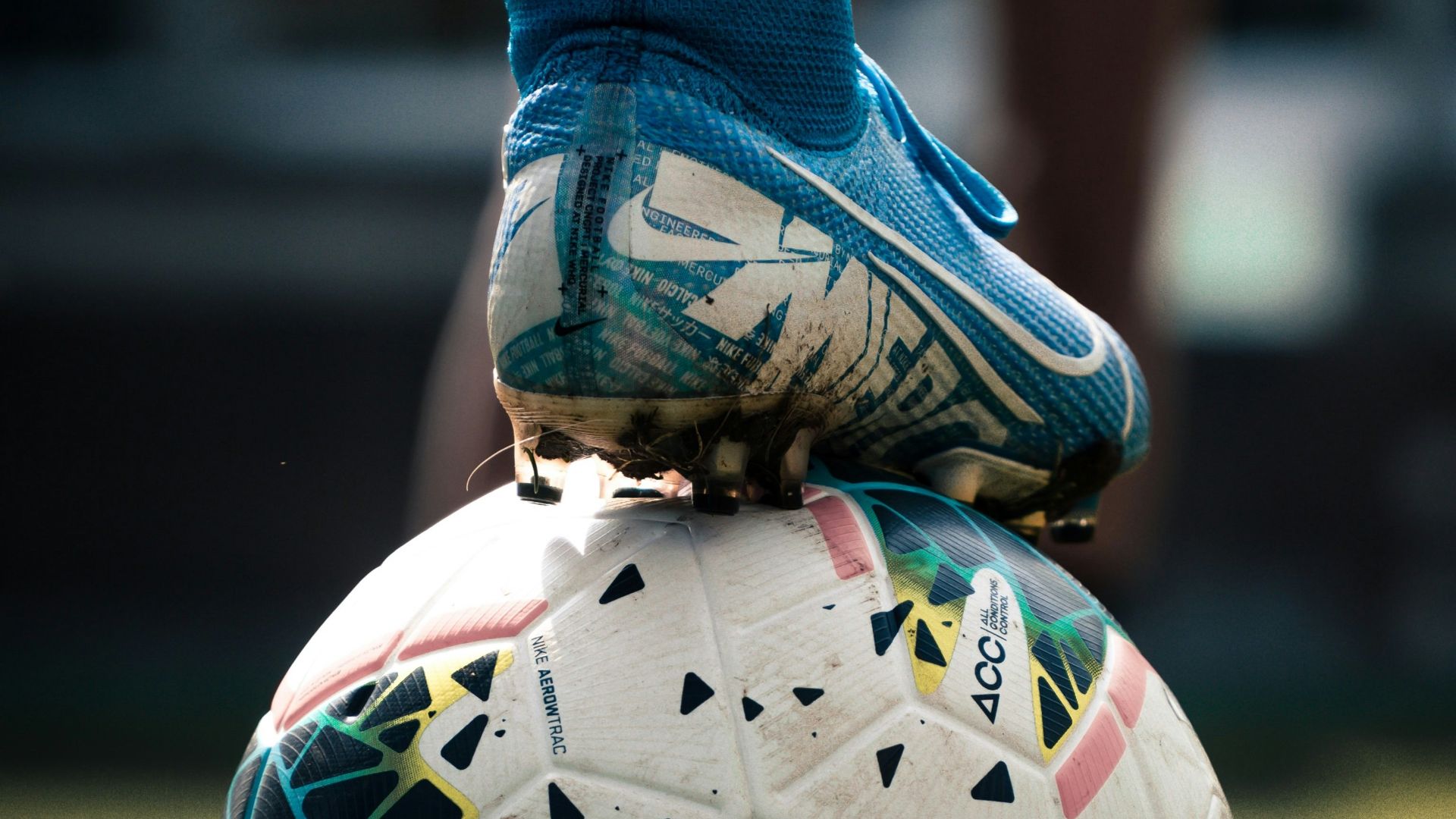 white and blue soccer ball on green grass field