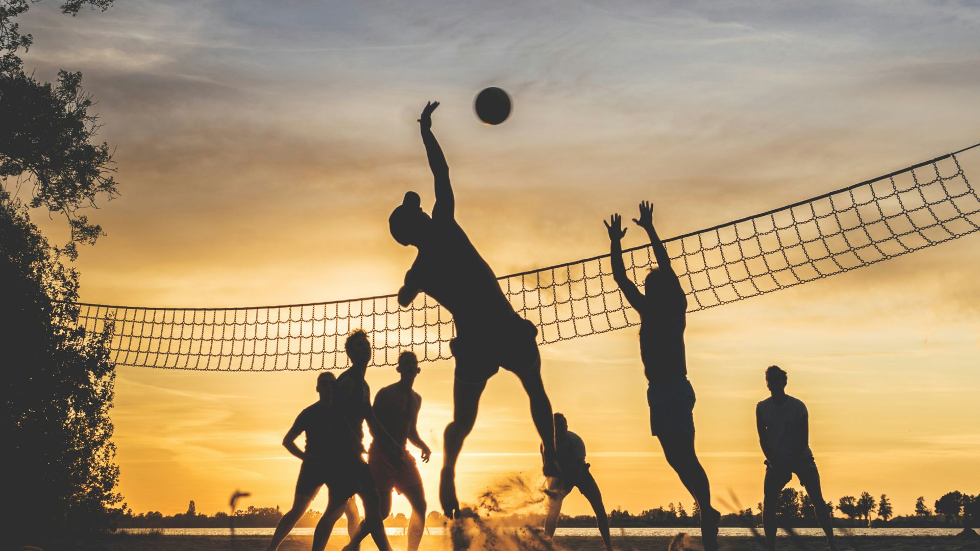 silhouette of people playing basketball during sunset