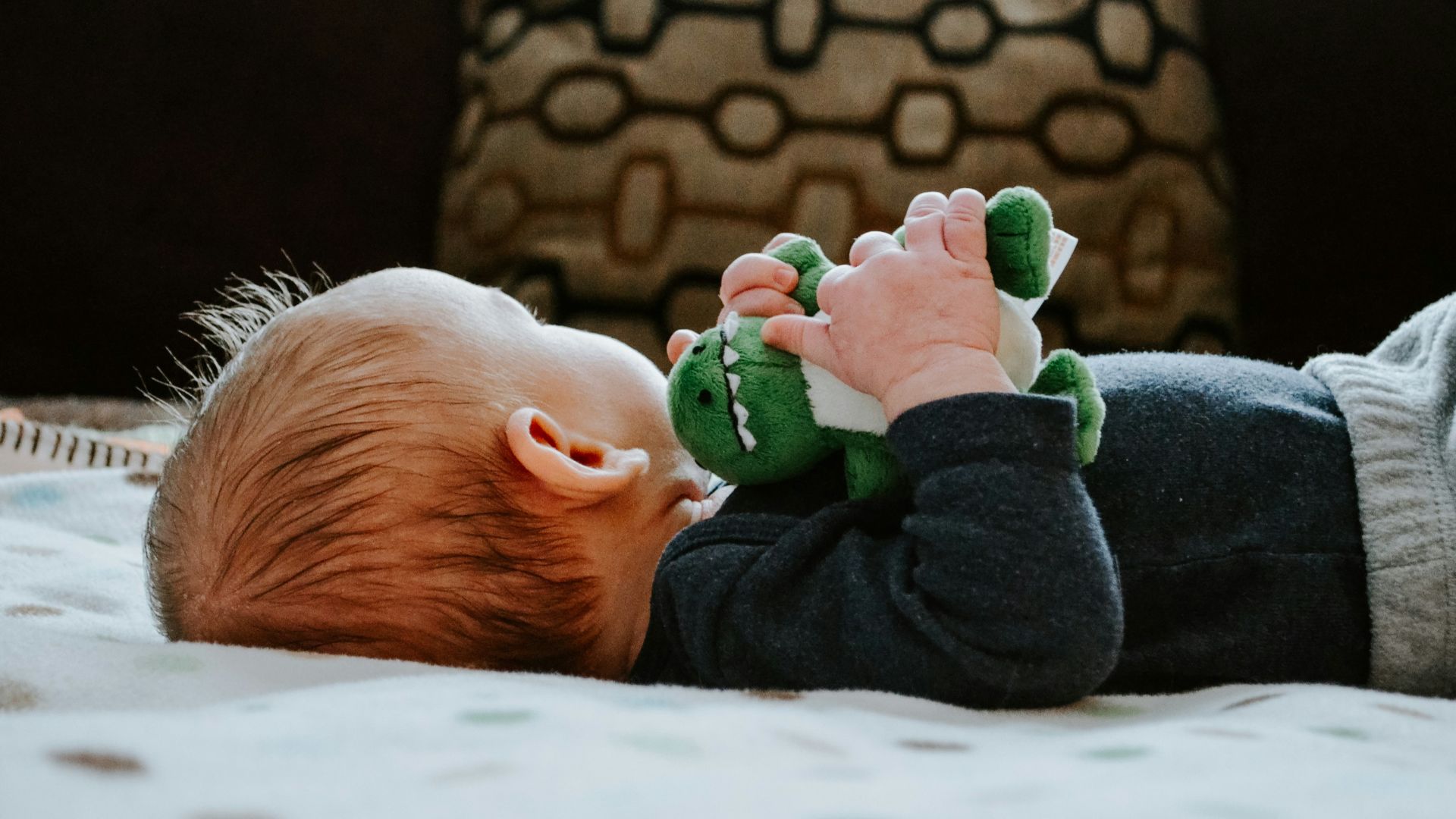 baby lying on white bed