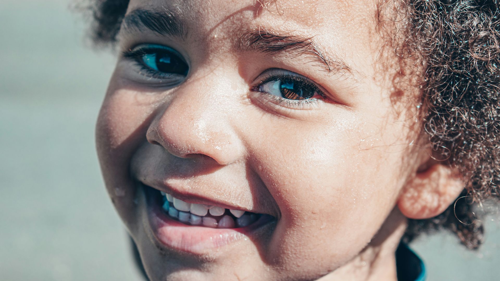 smiling woman with white and red flower on her ear