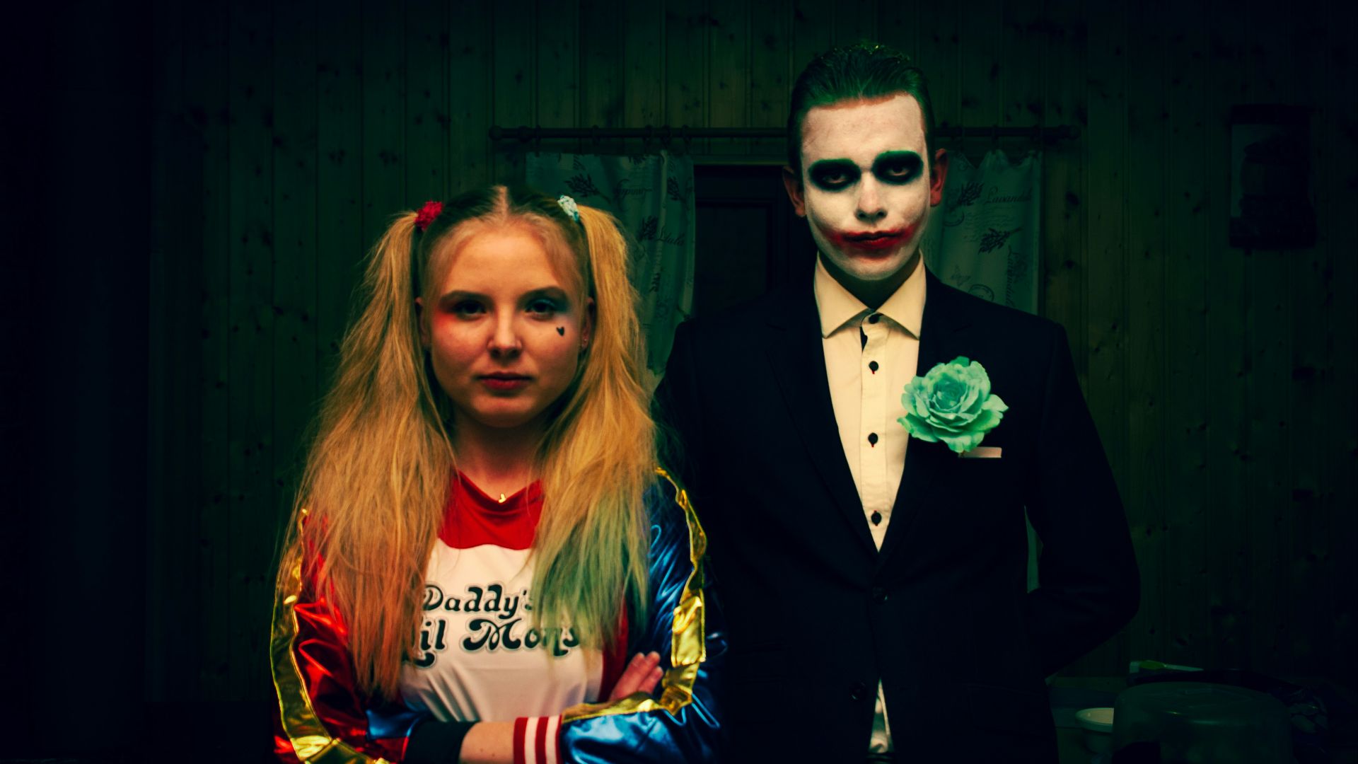 a man in a tuxedo and a woman dressed as the joker