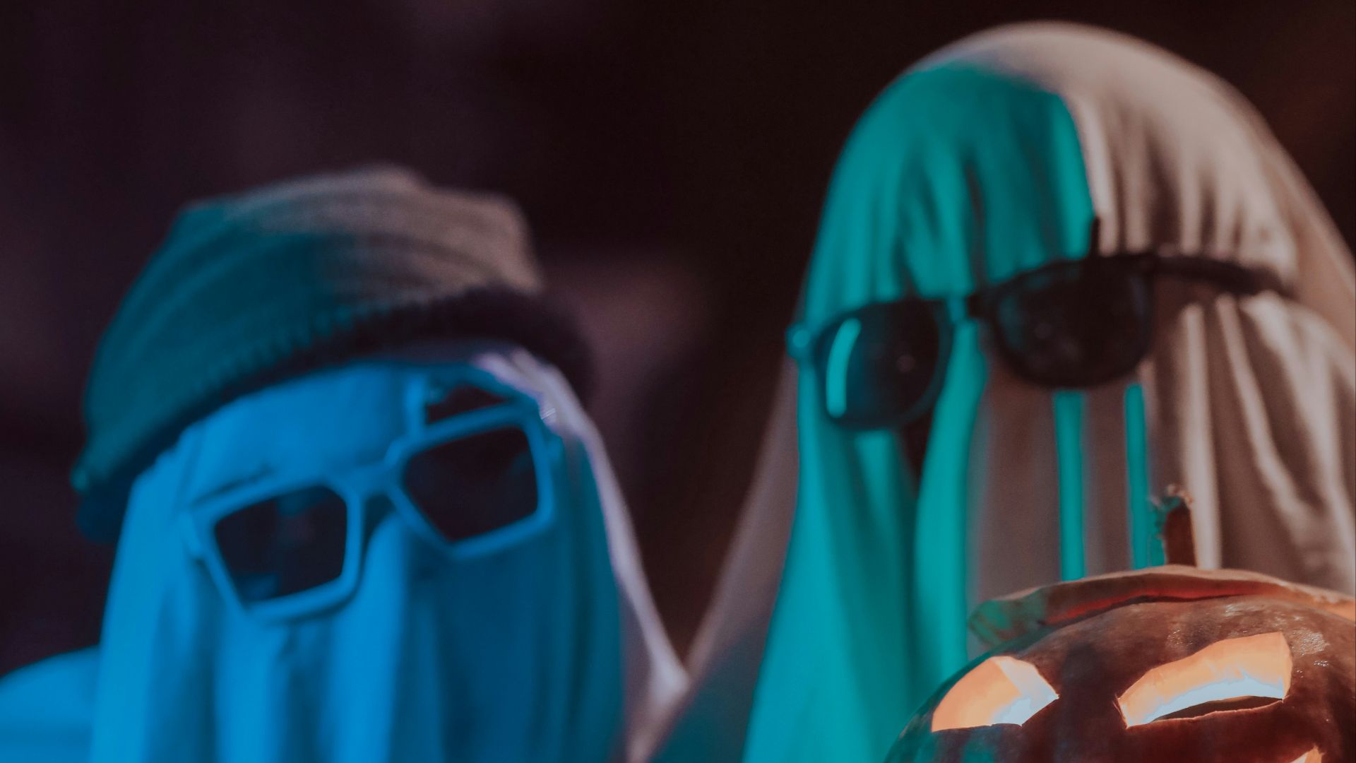 a person wearing a mask and holding a glass of beer