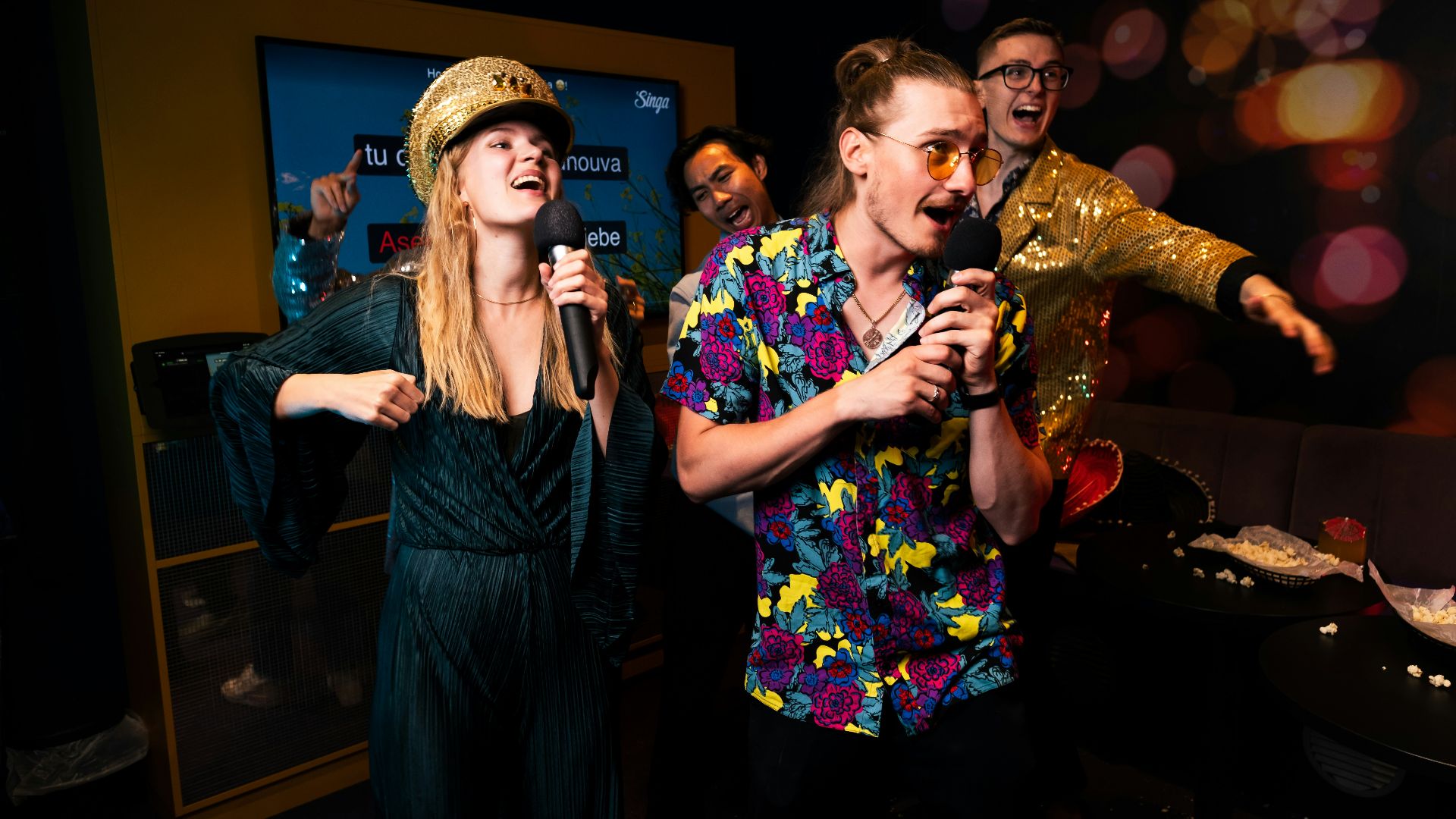 A group of people standing around each other in a room