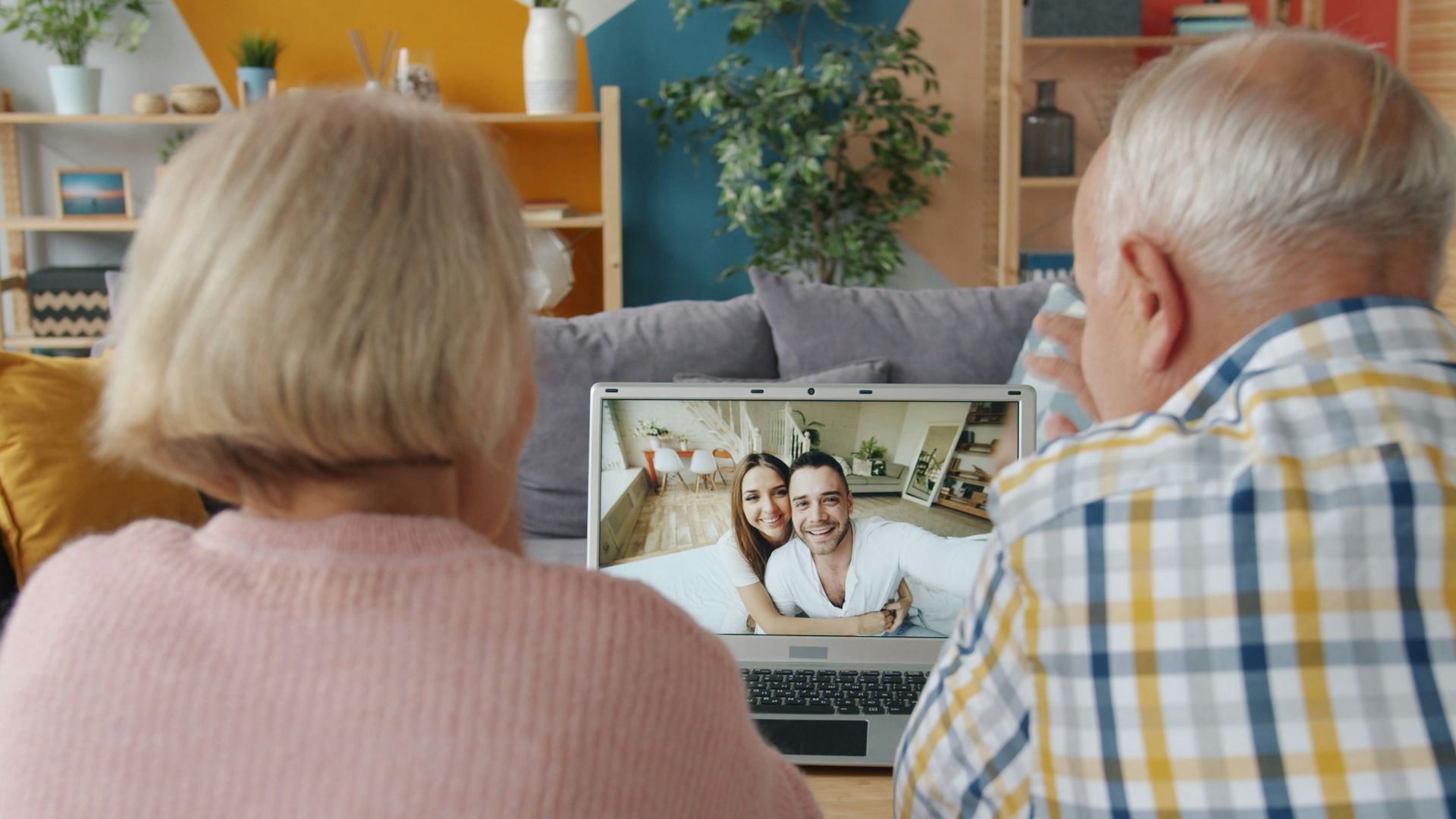 Elderly couple video calling with younger couple