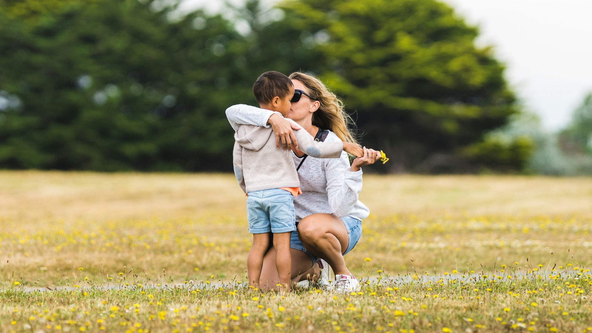 a couple of people that are standing in the grass
