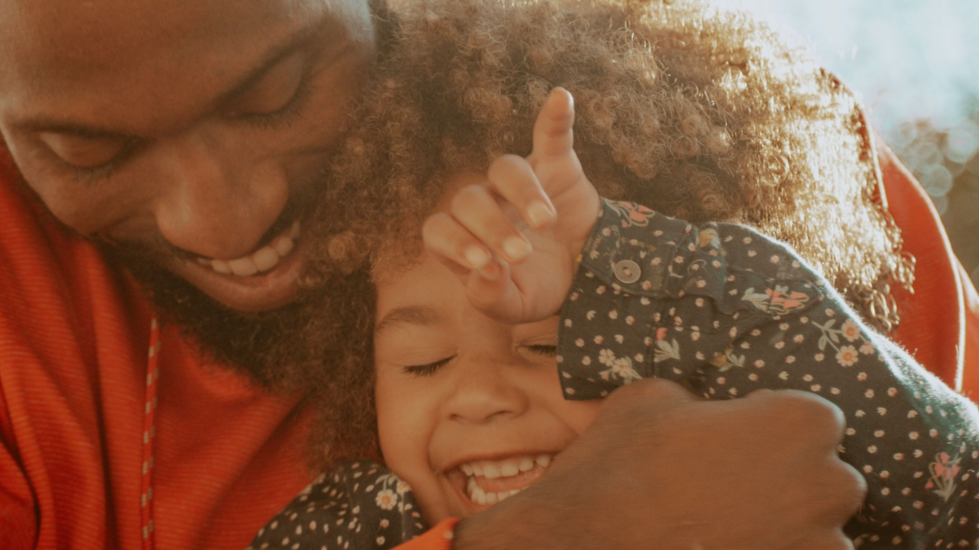 woman in red hoodie holding her hair
