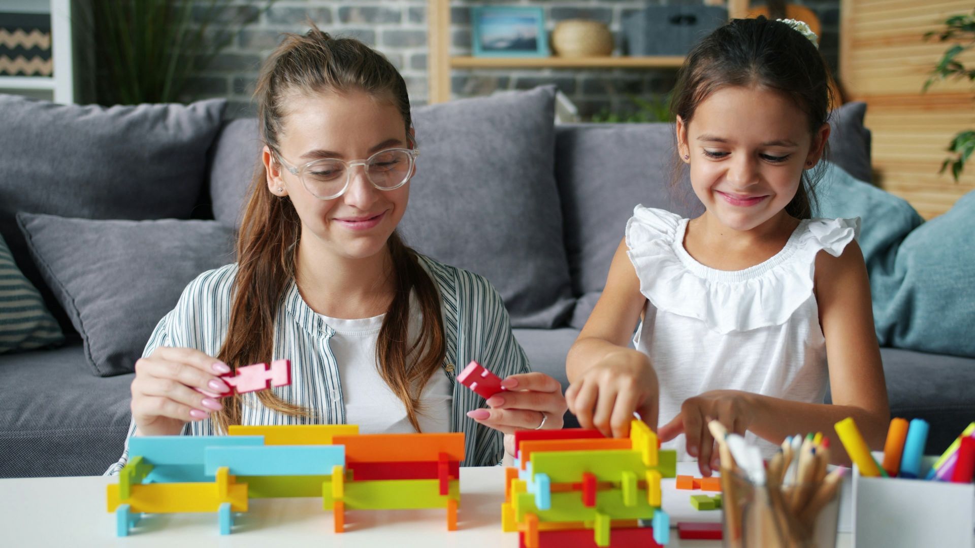 Woman and child building with colorful blocks