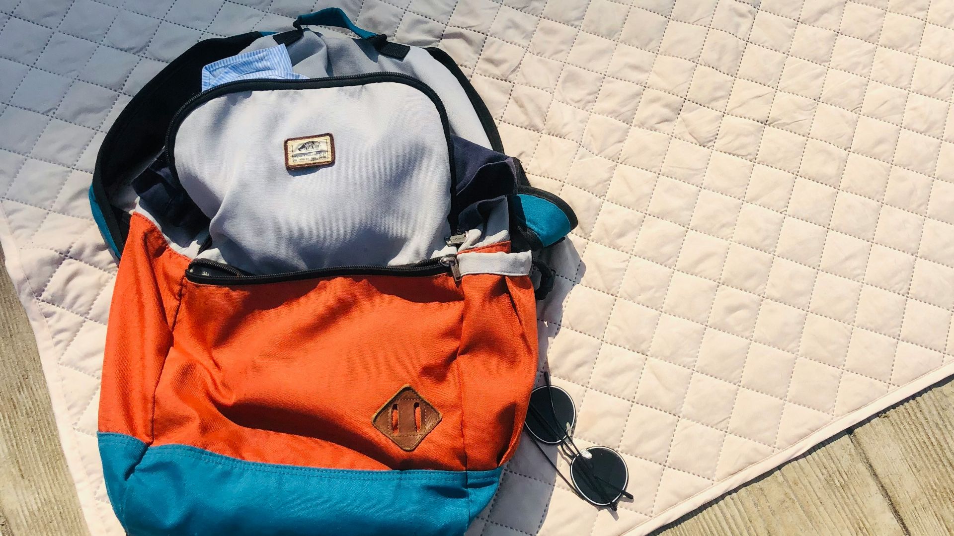 black and orange backpack on white floor