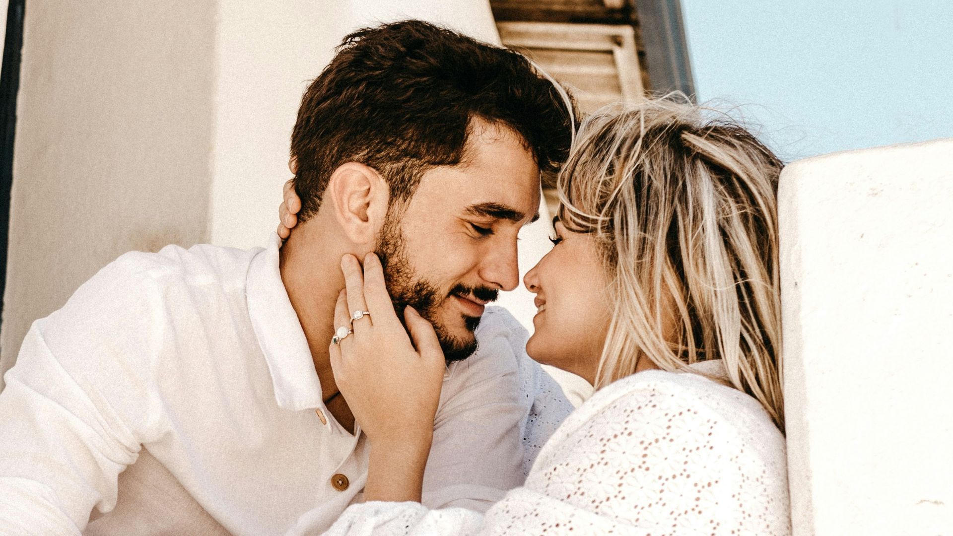 smiling man and woman about to kiss