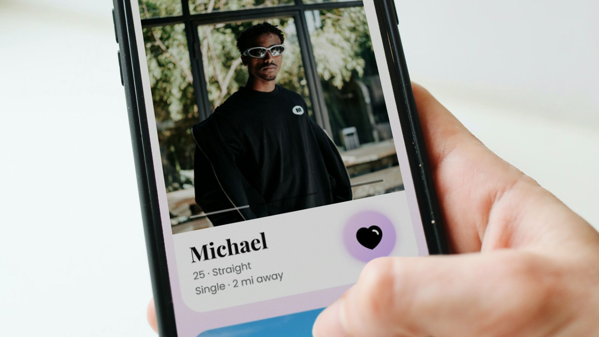 a person holding a cell phone with a picture of a man on it