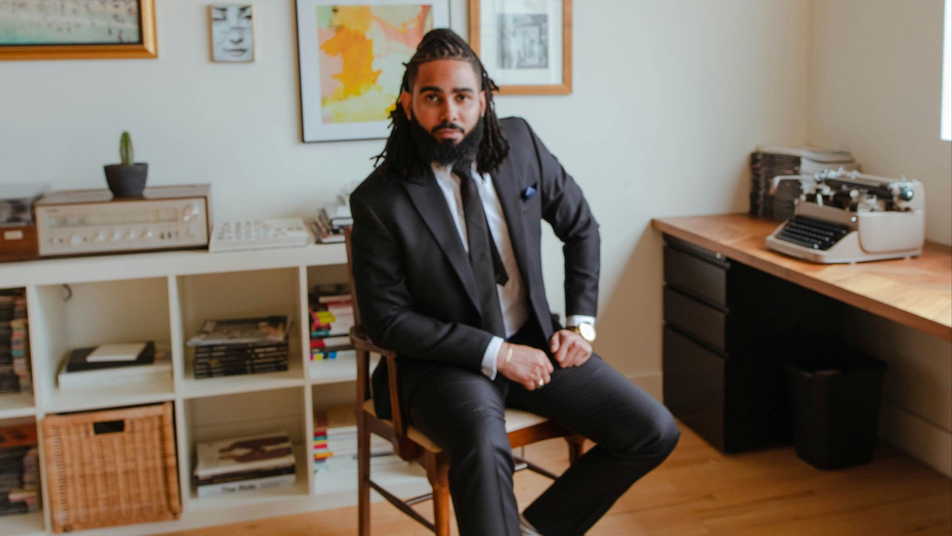 man in black jacket sitting on chair