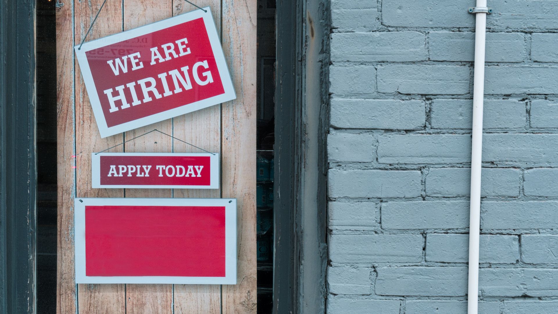 a sign that says we are hiring and apply today