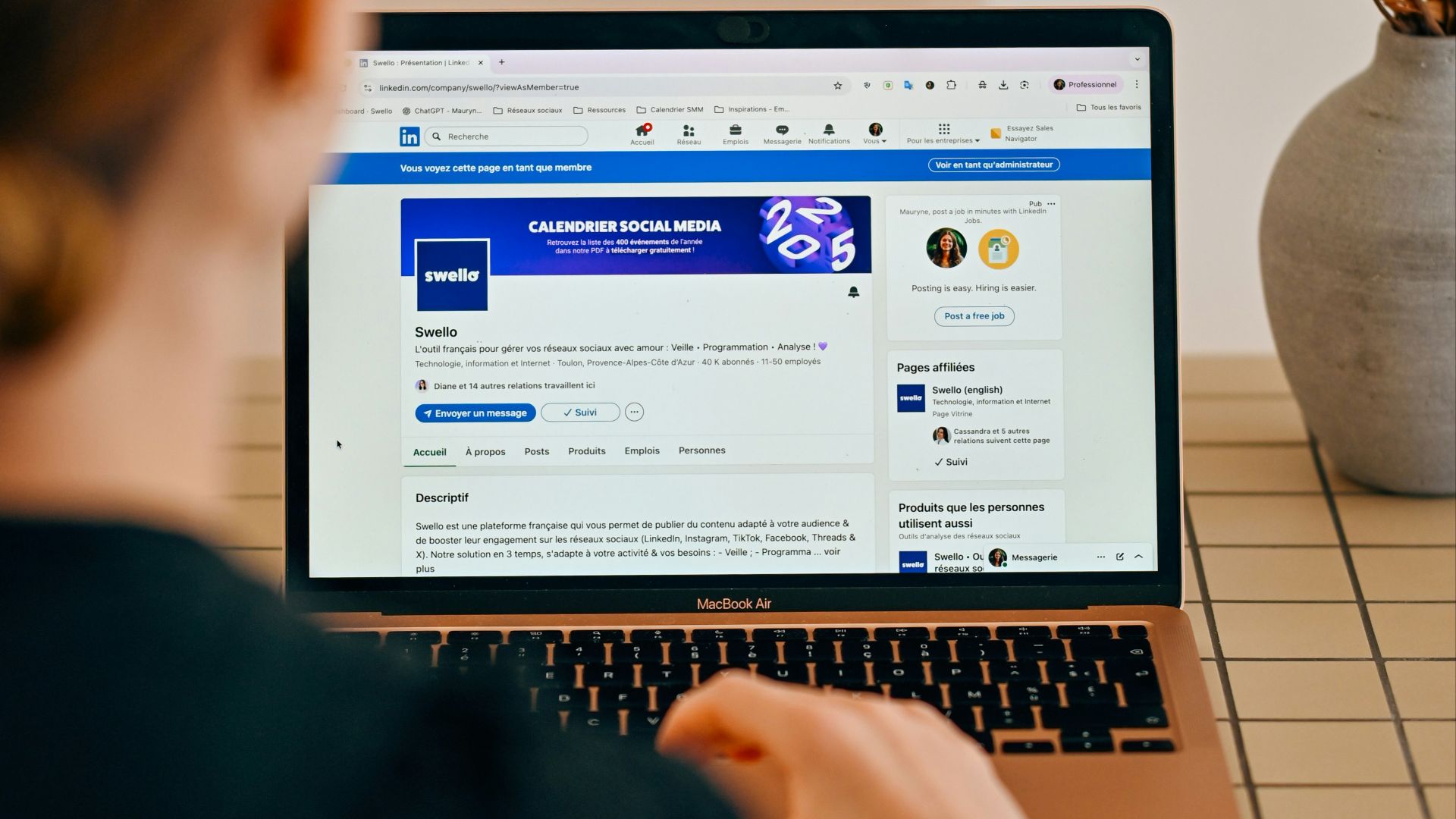 Woman using a laptop with social media open.