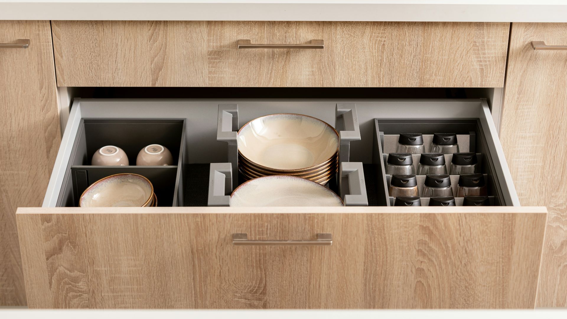 a kitchen drawer with dishes inside of it