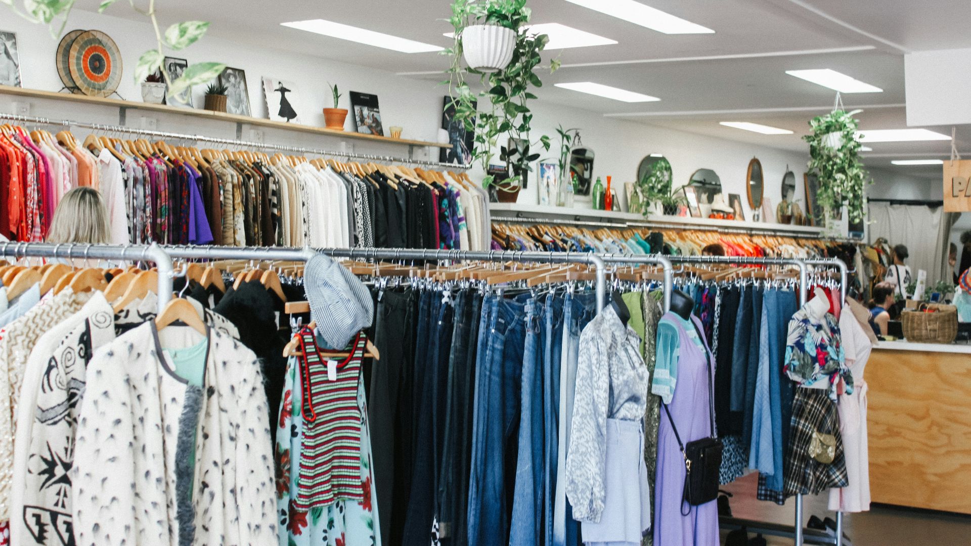 assorted-color clothes hanged inside department store with lights turned on