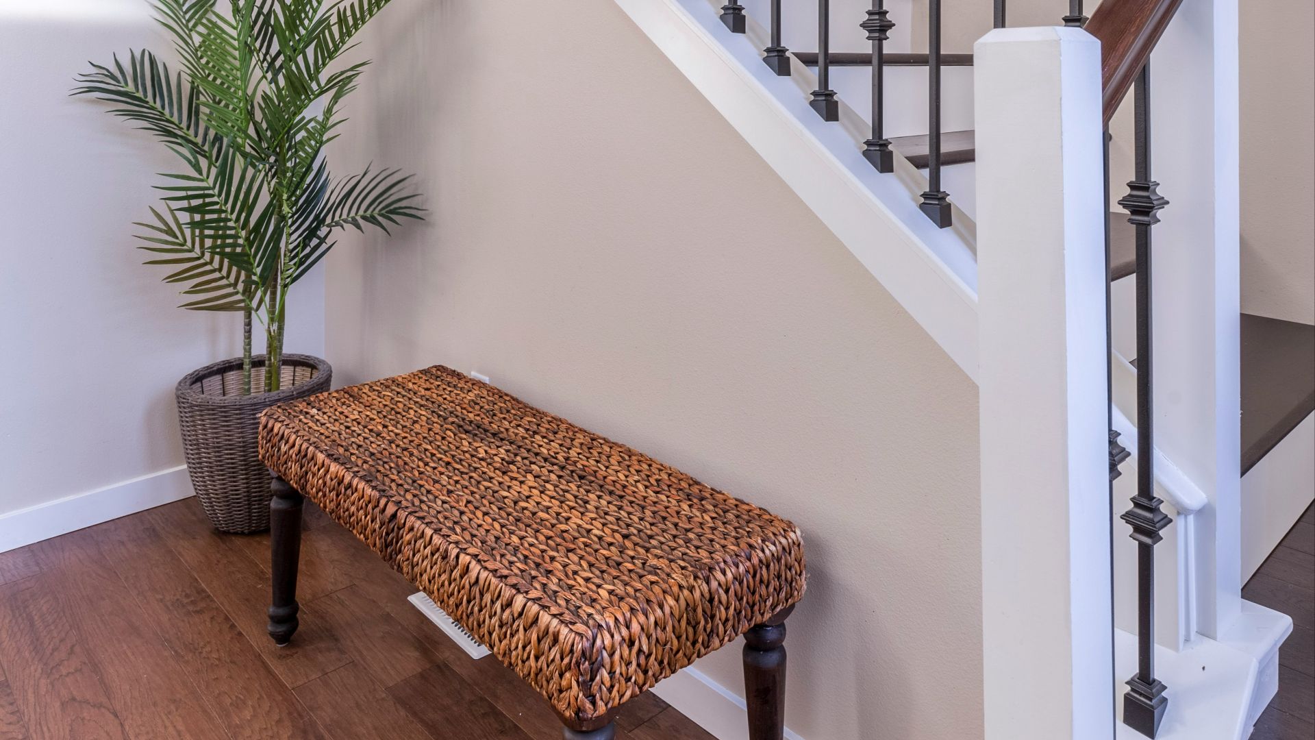 brown wooden bench near white stair