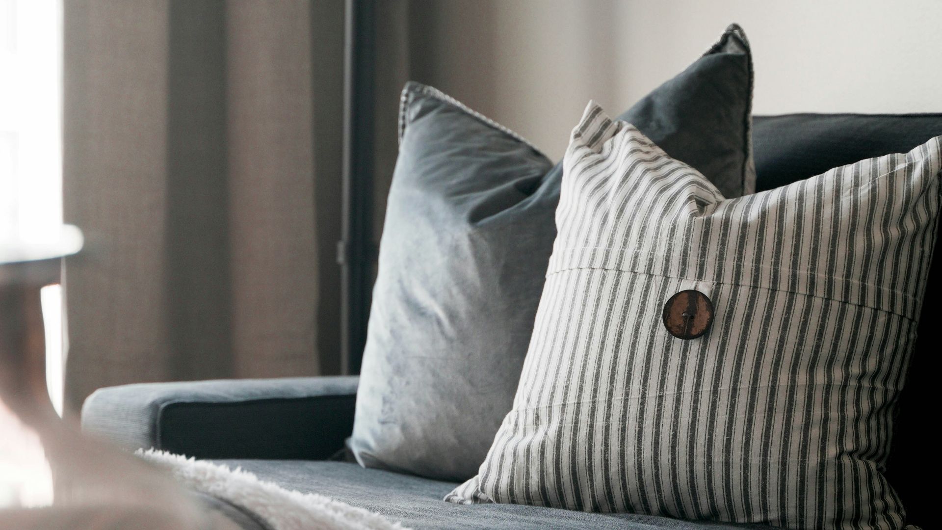 a living room with a couch and a lamp