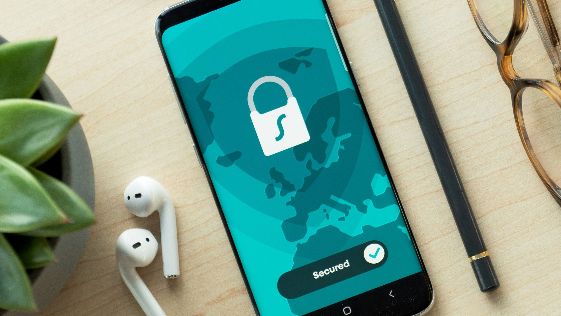 black iphone 5 beside brown framed eyeglasses and black iphone 5 c