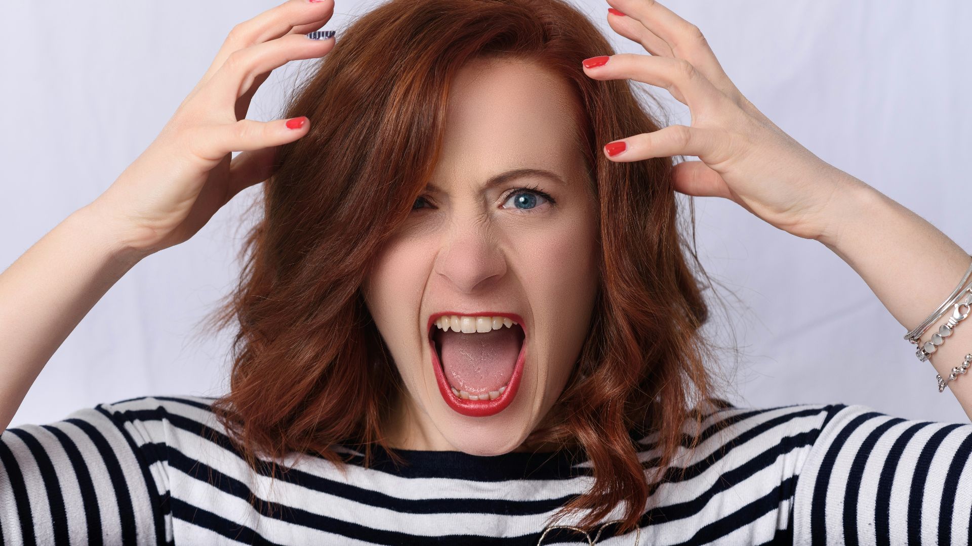 smiling girl in black and white striped shirt