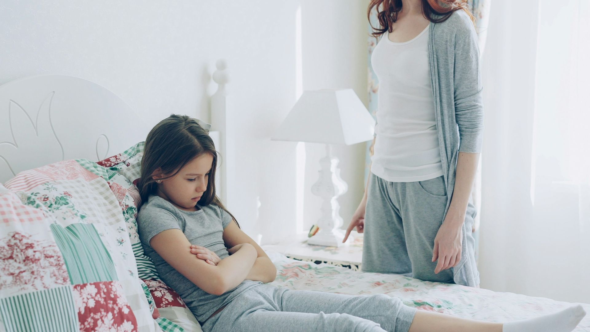A mother confronts her child, who is upset.