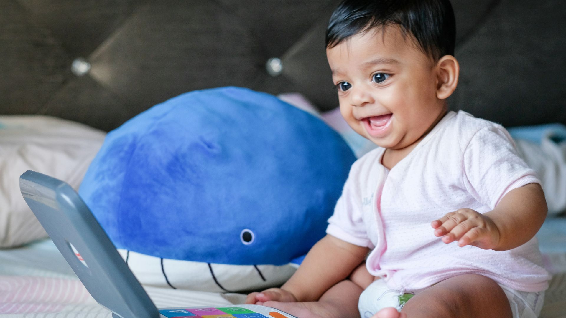 boy in white shirt sitting on blue ball