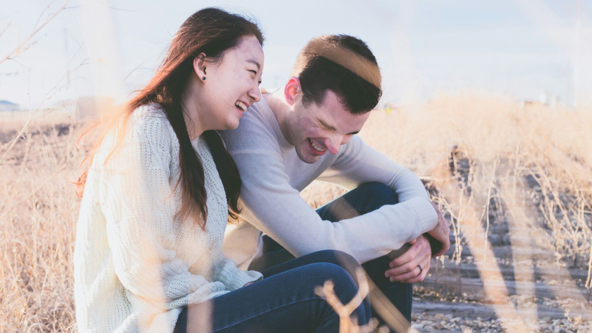 photo of man and woman laughing during daytime