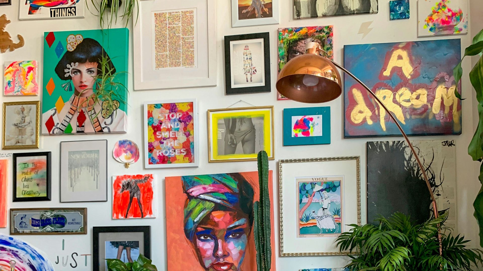 a living room filled with a blue couch and lots of pictures on the wall