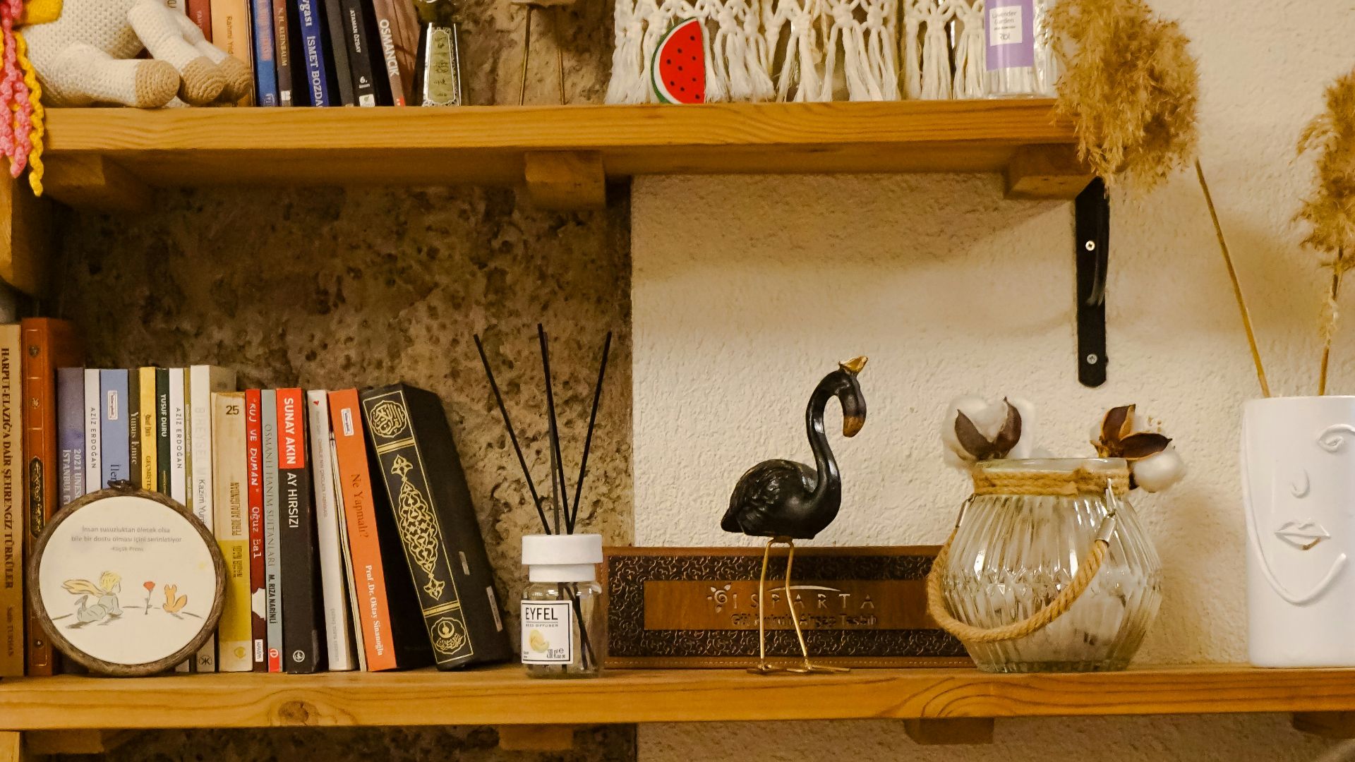 a room with a desk and shelves filled with books