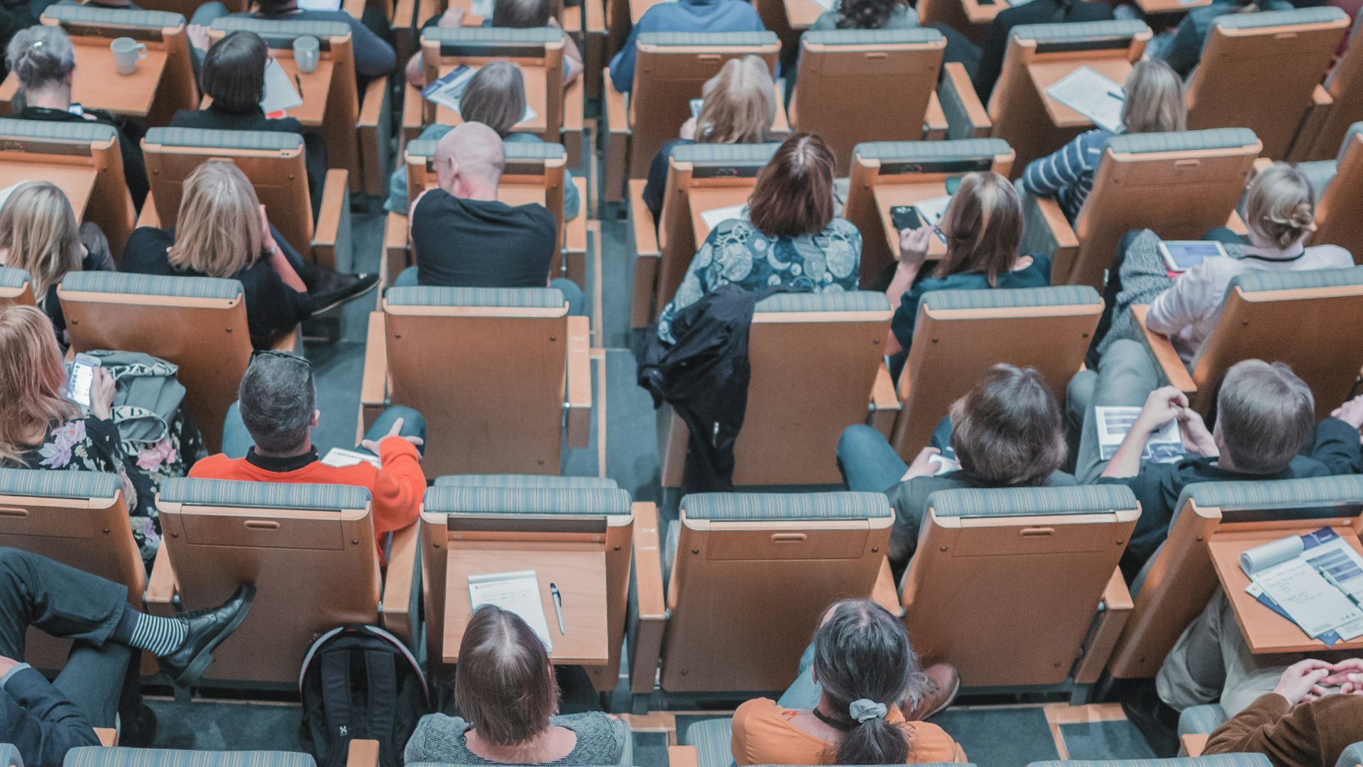 high-angle photography of group of people sitting at chairs