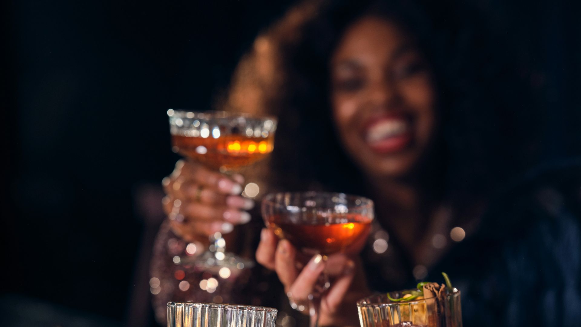 a group of people toasting with drinks