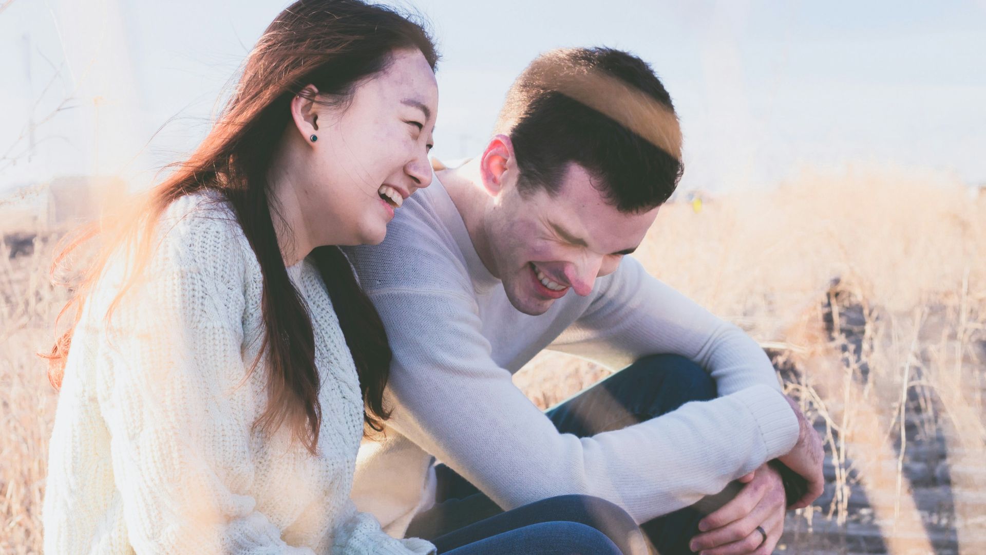 photo of man and woman laughing during daytime