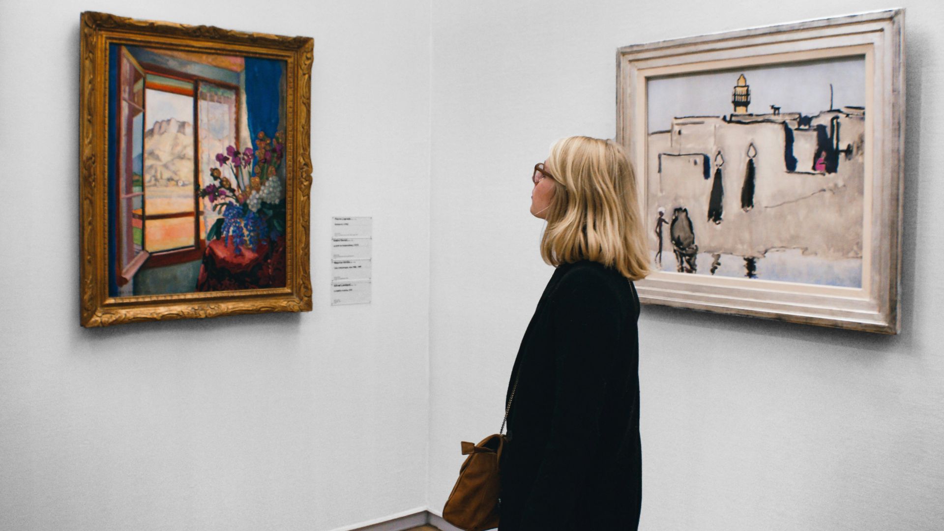 woman looking at painting